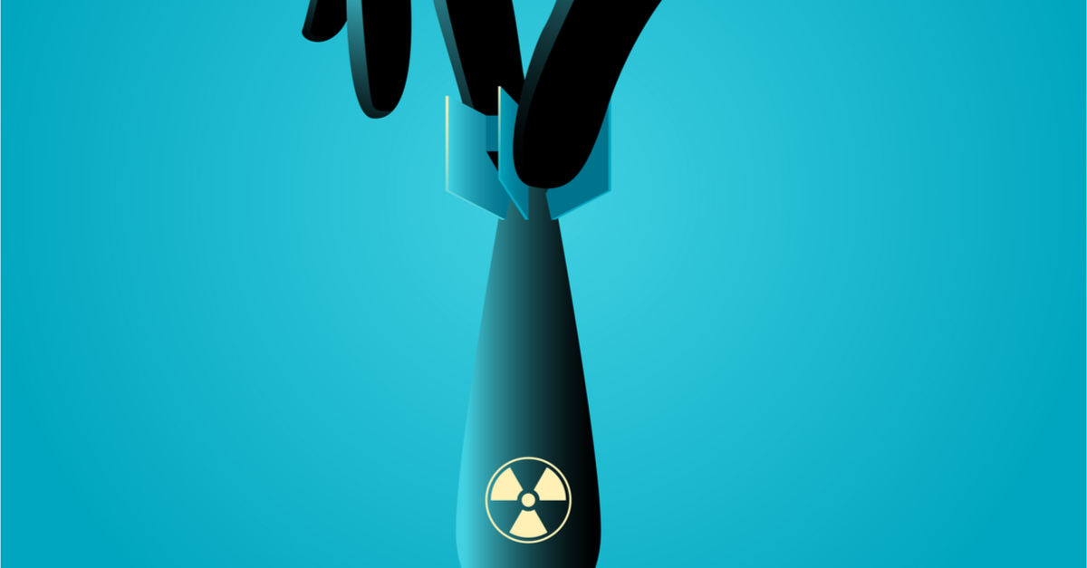 A hand dangles a nuclear missile.