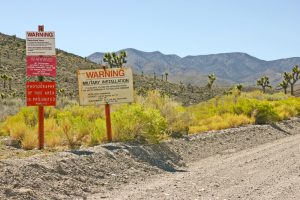 Signs mark the boundary of a restricted weapons testing site in Nevada. (Shutterstock)