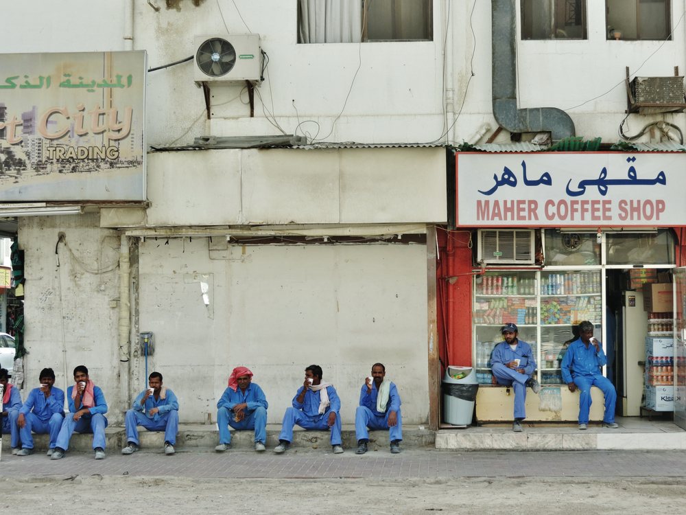 Foreign workers take a coffee break in Dubai, UAE (Shutterstock)