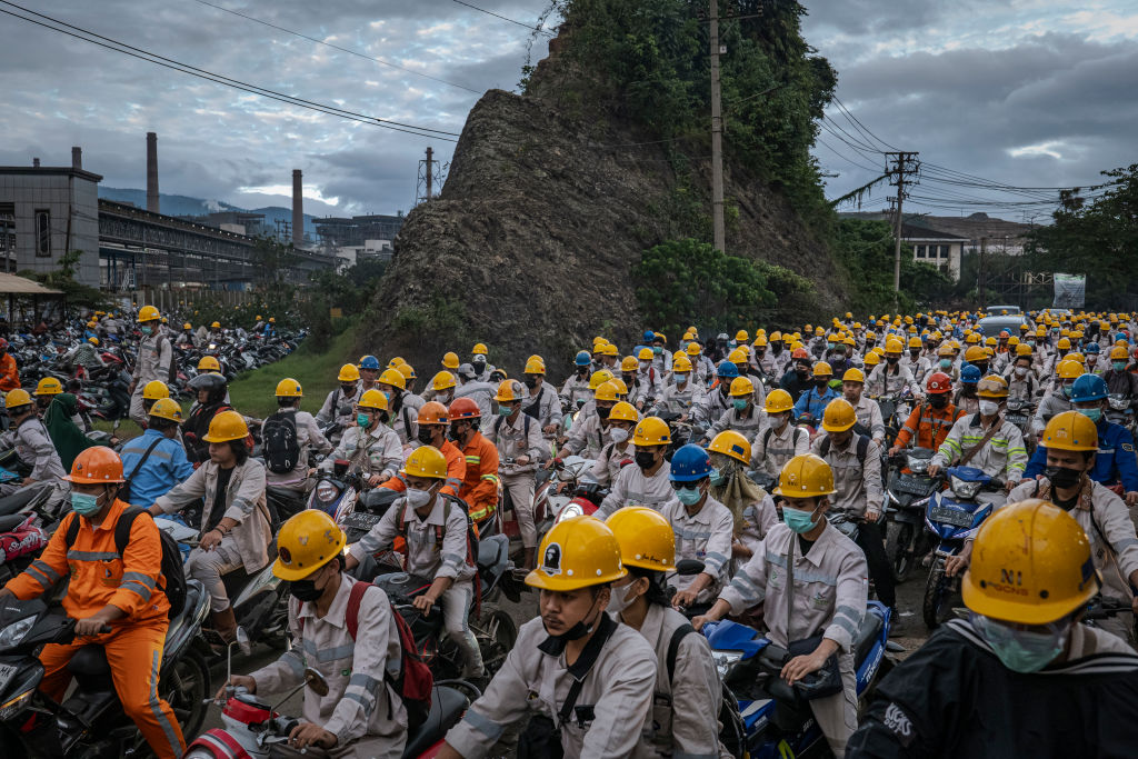 Employees change shifts near Indonesia Morowali Industrial Park (IMIP) in 2023 (Getty)