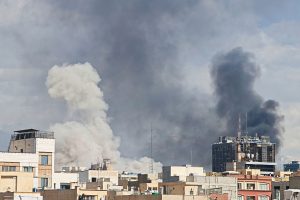 Plumes of smoke from U.S. and Israeli bombs rise over Tehran. (Getty)