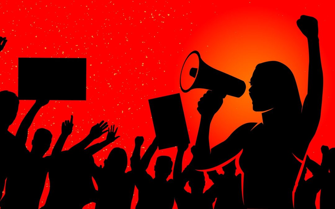 Silhouette,Of,Women,Protester,Standing,Leading,A,Speech,During,A